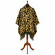 Gold and olive camo alpaca wool poncho – front view on a wooden mannequin stand: hooded poncho in mustard gold with forest-olive and black camouflage and dark olive fringe
