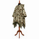 Camo alpaca wool poncho – three-quarter view on a mannequin showing the hood, button neck and fringed hem in olive, brown and sand camouflage