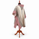 Cream and burgundy striped hooded poncho on a mannequin, back three-quarter
