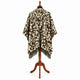 Camo alpaca wool poncho – back view on a mannequin showing the hood and the full-width camouflage pattern with olive fringe