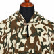 Camo alpaca wool poncho – close-up of the neckline with wooden button and loop closure and the soft woven camouflage texture