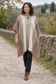 Woman wearing the Rasu striped llama wool poncho on a country walk