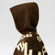 Clint Eastwood alpaca wool poncho – a brown hooded poncho with geometric patterns is worn, facing sideways against a plain, light background