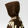 A brown hooded garment with geometric patterns is worn, facing sideways against a plain, light background.