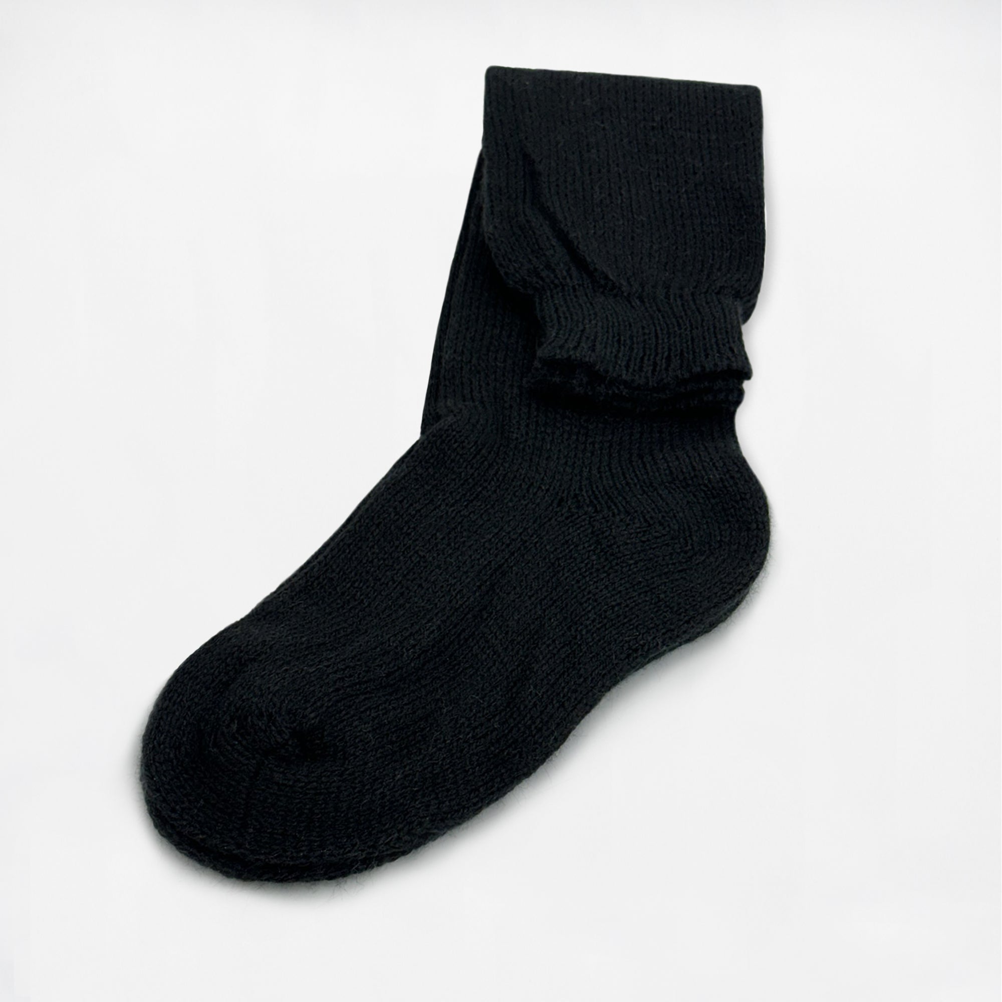 A single black sock lies flat against a plain white background, displaying its ribbed texture and folded cuff in a neat arrangement.