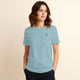 Woman wearing 100% organic cotton premium unisex t-shirt, soft cotton blend, fair trade, Andean Sky logo sky blue