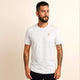 Man wearing 100% organic cotton premium unisex t-shirt, soft cotton blend, fair trade inspired, white with logo