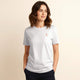 Woman wearing 100% organic cotton premium unisex t-shirt, soft cotton blend, fair trade inspired, white with logo