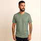 Man wearing 100% organic cotton premium unisex t-shirt, soft cotton blend, fair trade, Paramo Green plain olive green