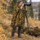 Camo Inti alpaca wool poncho – wildlife photographer with a camera on a tripod among autumn trees, wearing the gold and olive camouflage poncho