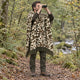 Camo Sacha alpaca wool poncho – man birdwatching with binoculars in a woodland, wearing the olive, brown and sand camouflage hooded poncho