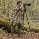 Camo Sacha alpaca wool poncho – wildlife photographer with a camera on a tripod in the forest, wearing the camouflage poncho over a jacket
