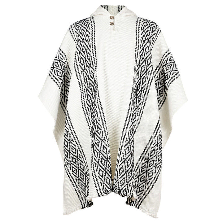 A white poncho featuring black diamond patterns is displayed against a plain background. It has a high collar with two buttons and flowing, wide sleeves.