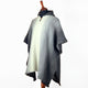 Llama Wool Hooded Poncho – poncho displayed on a mannequin, featuring a grey and white striped pattern and a collar with a brown button. The background is plain white