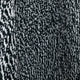 Knitted fabric features a close-up view of black and white interwoven yarns, creating a textured, speckled pattern. The fabric appears slightly draped, highlighting the intricate loops and weave.