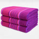 Chone baby alpaca wool blanket – three folded, vibrant pink and purple striped blankets are stacked neatly against a plain white background
