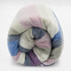 Yunga baby alpaca wool blanket – a rolled, multicolored striped blanket with pink, blue, gray, and cream hues is set against a plain white background