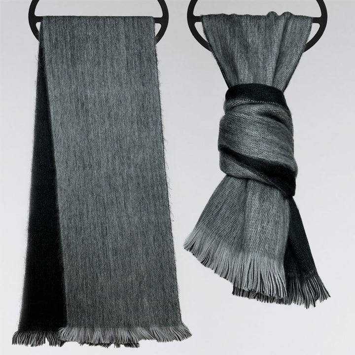 Two gray scarves hang on circular hooks; one drapes down smoothly, while the other is tied in a neat knot. The background is a plain, light surface.