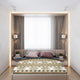 A neatly made bed with patterned blanket, flanked by wall lamps and curtains, in a modern bedroom. Two pillows rest against the headboard. Nearby, a plant on books titled Walter Finance.
