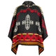 A colorful poncho features bold geometric patterns in red, black, and beige, with large crosses and triangular designs. It hangs freely against a plain white background.
