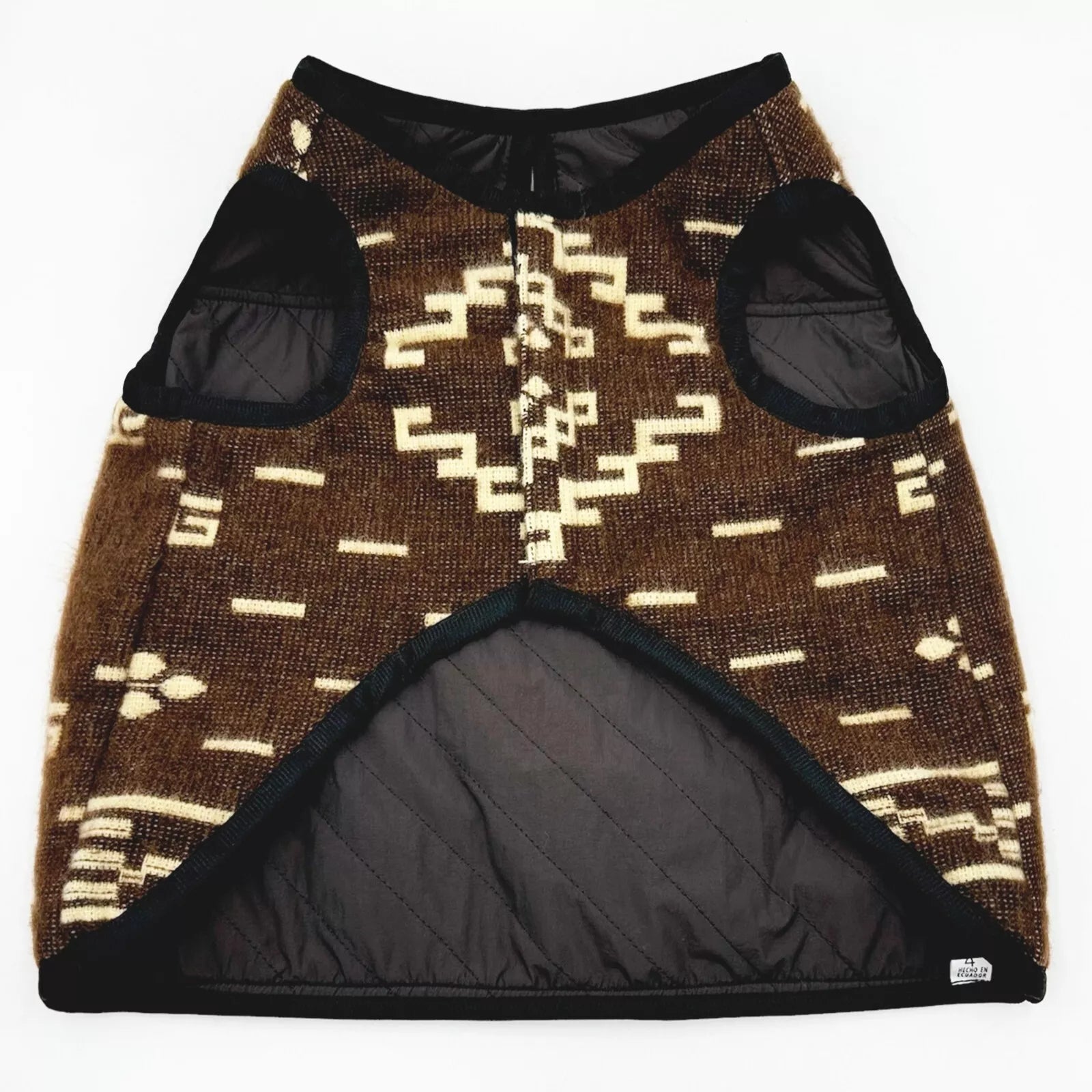 Quilted, brown patterned vest with black armholes and lining lies flat; features geometric design and small label.