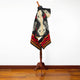 A mannequin displays a multicolored, patterned poncho featuring geometric designs in a room with wooden flooring and a white wall background.