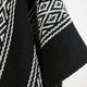A textured black fabric with white geometric patterns runs diagonally, forming a linear and diamond-shaped motif, creating a visually striking and dynamic design that appears soft and woven.