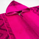 Macas kids alpaca hooded poncho – a bright pink hooded poncho features geometric patterns and a wooden button. The fabric is textured and the hood is laid back, highlighting intricate designs in a soft material