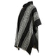 A black poncho with white, geometric diamond patterns drapes elegantly, featuring wooden buttons near the collar, set against a plain white background.