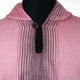 A pink woolen garment with vertical striped stitching and a small button near the collar, displayed on a black mannequin. The garment's texture appears soft and fuzzy.