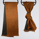 Two brown and gray scarves hang on circular racks; one is draped straight, and the other is tied in a knot, set against a plain gray background.