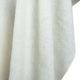 White textured fabric drapes vertically, creating soft folds and shadows, suggesting a cozy, warm material suitable for garments or home textiles.
