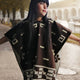 Kids Clint Eastwood alpaca wool poncho – a person wearing a patterned brown poncho stands with arms outstretched. They are on a cobblestone path with trees and archways in the background, suggesting an outdoor setting