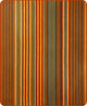Putumayo baby alpaca wool blanket – a rectangular blanket exhibits vertical stripes in shades of orange, brown, teal, and rust, creating a warm, earthy color palette in a home setting