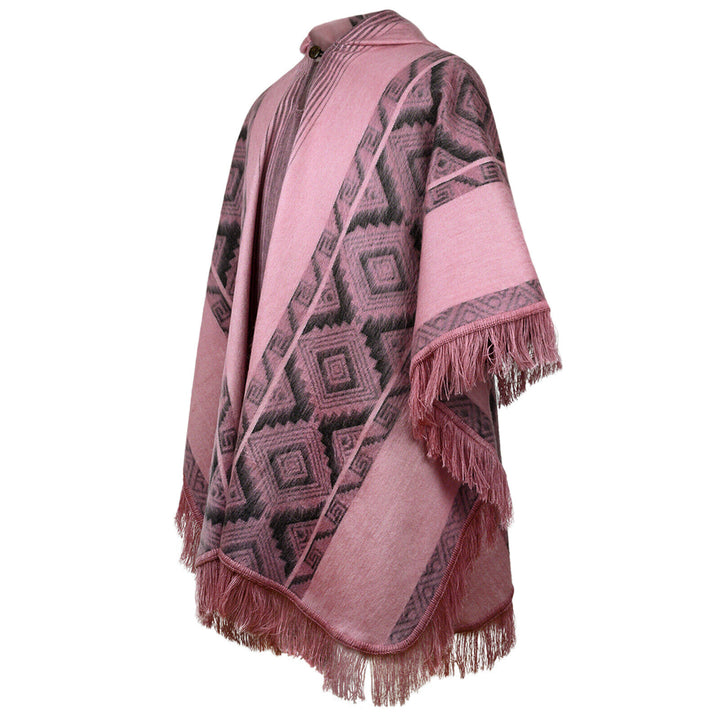 Pink poncho with geometric patterns and fringe details drapes elegantly. It's positioned on a neutral background, showcasing intricate diamond designs in a soft, textured fabric.