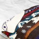 Qhusi extra large alpaca wool blanket – a patterned blanket with geometric designs lies folded, displaying vivid colors like blue, red, and brown, set against a plain white background
