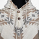 Hooded garment with geometric patterns, featuring brown buttons and a woven texture. The design includes cream, gray, and brown colors, providing a southwestern aesthetic on a mannequin display.