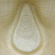 A woven straw hat, viewed from above, showing intricate, symmetrical patterns within its natural beige structure, suggesting craftsmanship. The background consists solely of the hat's textured material.