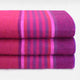 Chone baby alpaca wool blanket – three folded, fluffy blanket with pink and purple stripes stacked neatly on a white surface