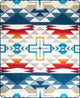 A blanket displays a geometric, tribal-inspired pattern in red, blue, orange, and gray. It features cross and triangular shapes in a repeating sequence, creating a vibrant, symmetrical design.