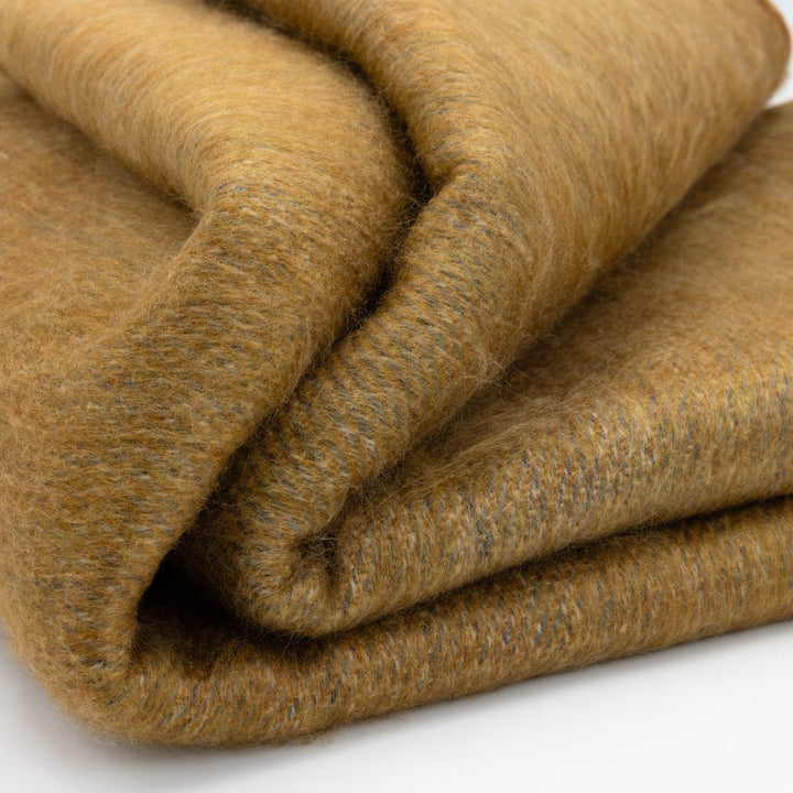 Chilintomo double density baby alpaca wool blanket – folded brown blanket on a white background