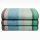 Sucua baby alpaca wool blanket – a neatly folded stack of three striped blankets features blue, green, and gray tones against a plain white background, conveying a sense of cozy organization