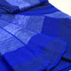 Chibuleo baby alpaca wool blanket – blue fabric lays in layered folds, highlighting its soft texture and gradient color, within a close-up view showing subtle variations and stitching patterns