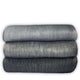 Suncamal baby alpaca wool blanket – three folded blankets, arranged in a stack, show shades of gray from light to dark. They rest against a plain white background, highlighting their soft, textured surface