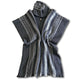 Llama Wool Hooded Poncho – a dark gray wool vest with vertical white and black stripes, featuring a button-up front and folded collar, laid flat on a white background