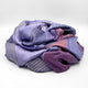 Ochoa baby alpaca wool blanket – a soft, multicolored fabric with purple and blue stripes is loosely folded, creating a layered texture against a plain white background