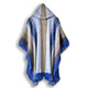 A hooded poncho hangs elegantly, displaying a gradient pattern of blue and gray with fringed edges. It is positioned against a plain white background.