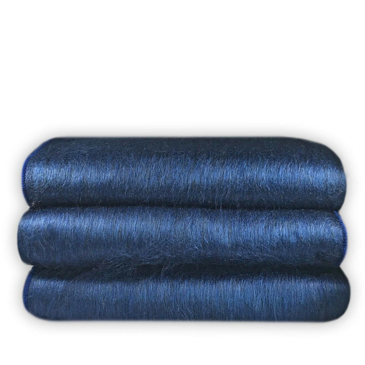 Alpamalag baby alpaca wool blanket – three neatly stacked rolls of deep blue mohair fabric, displaying a soft and shiny texture, against a plain white background