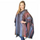 A person wearing a multicolored striped poncho stands confidently with hand on hip, in front of a plain white background.