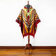 Guismi alpaca wool hooded poncho – a colorful poncho with geometric patterns displayed on a wooden mannequin stand, set against a plain white background and wooden floor